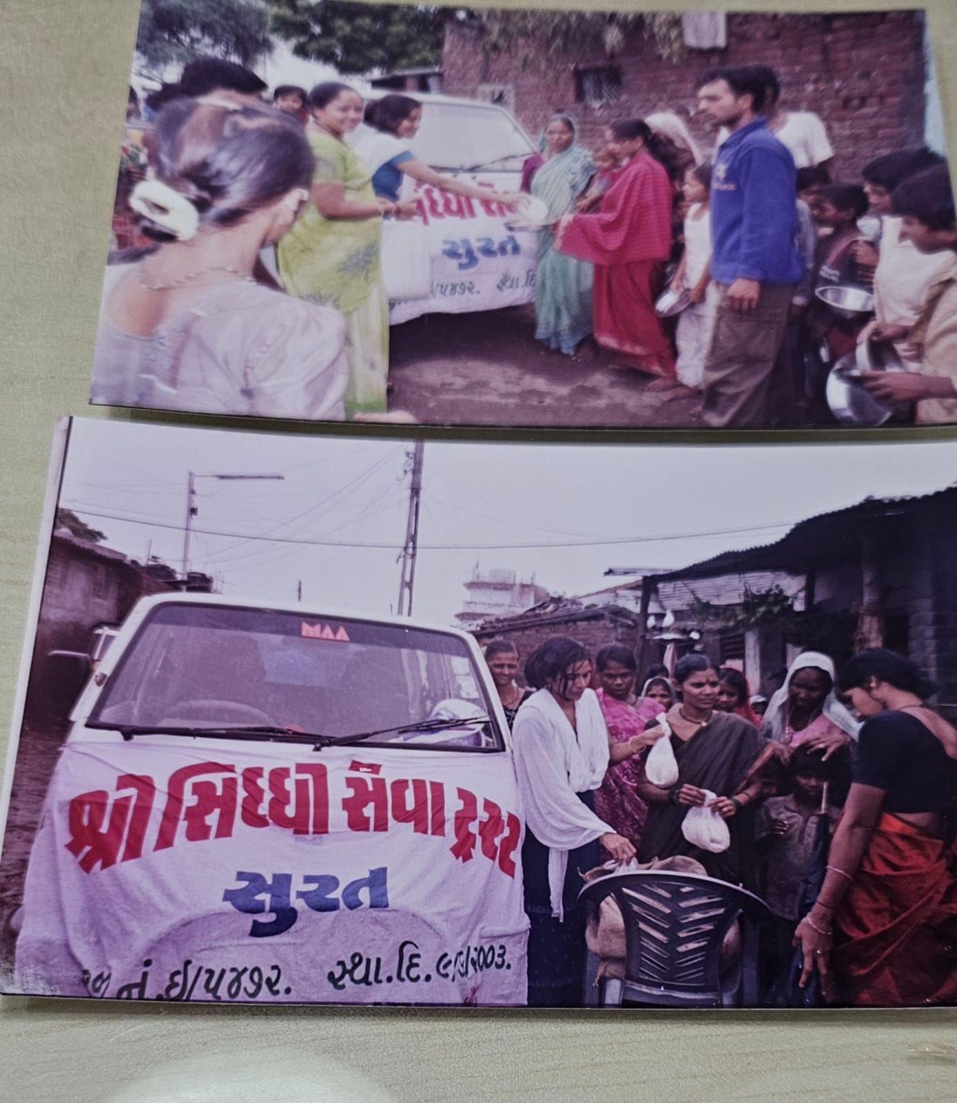 Volunteers distributing food packets from the Trust's relief van in a flood-affected area