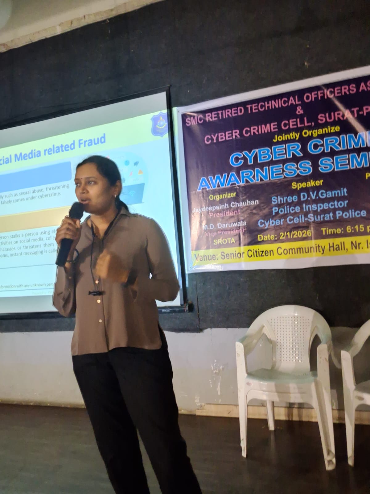 A speaker presenting on social media fraud at a cyber crime awareness seminar